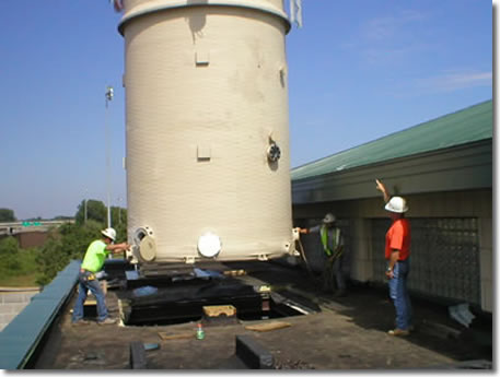 Air-stripping tower being lowered into place