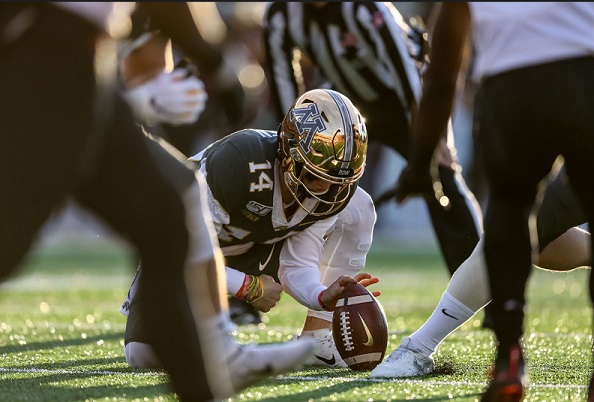 Casey O'Brien holding football