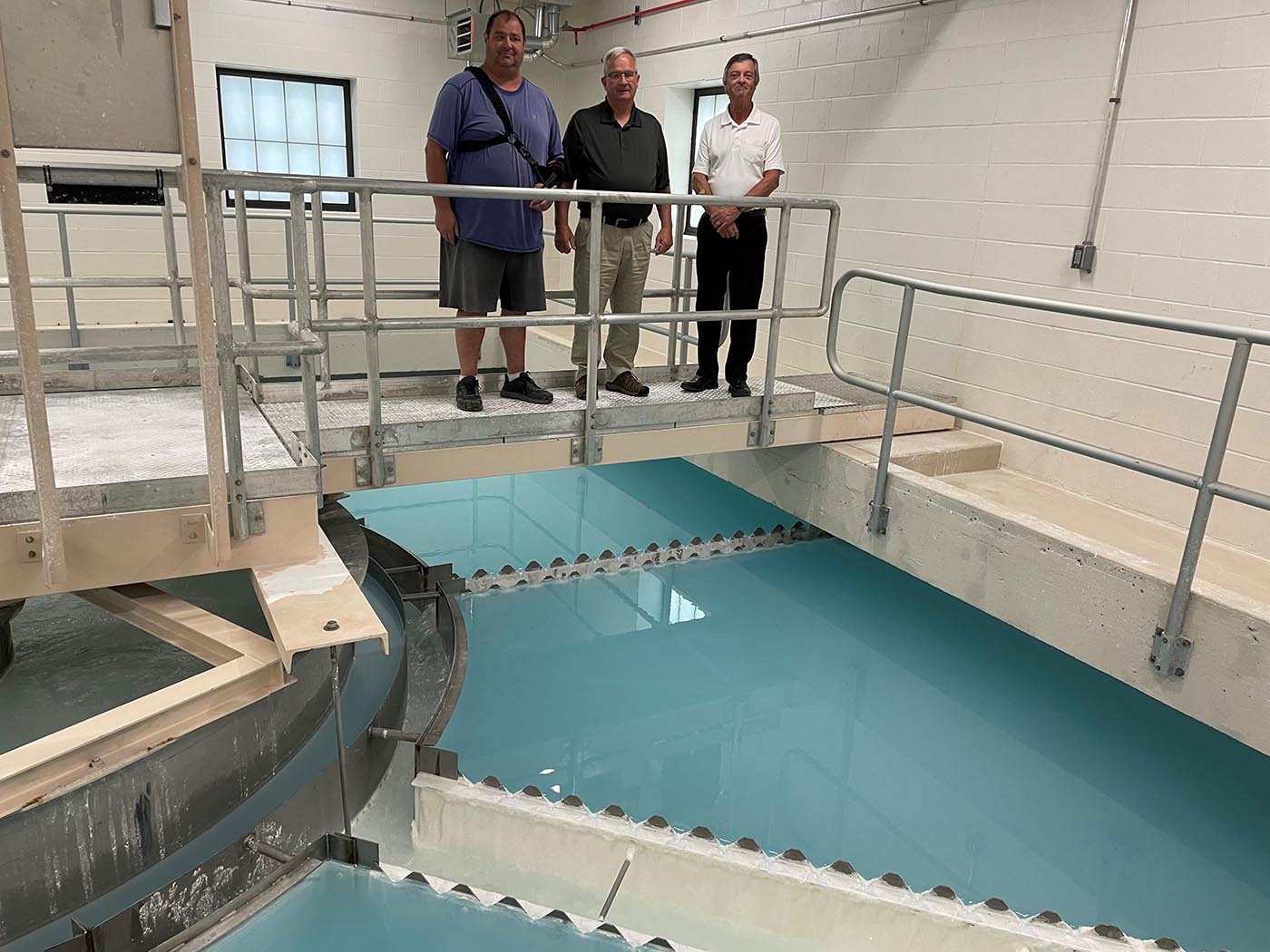 Joel Adelman, Myron Koets, and Jeff Jones over the clarifier