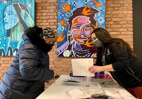 Woman serving a community member with paperwork