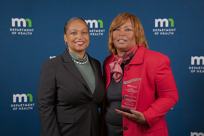 Angela Watts receiving award from Commissioner Cunningham.