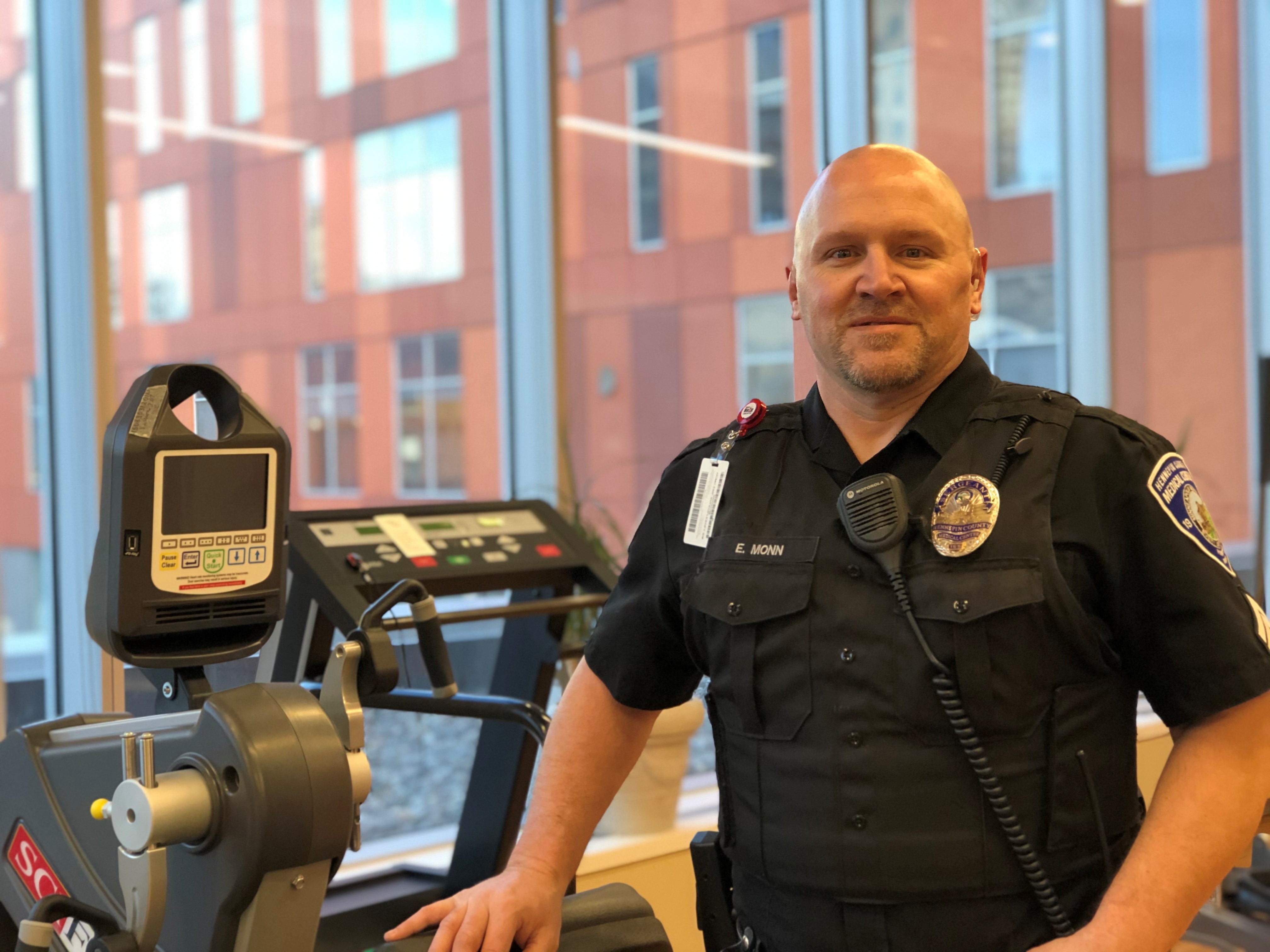 image of Eric standing next to an exercise machine. 