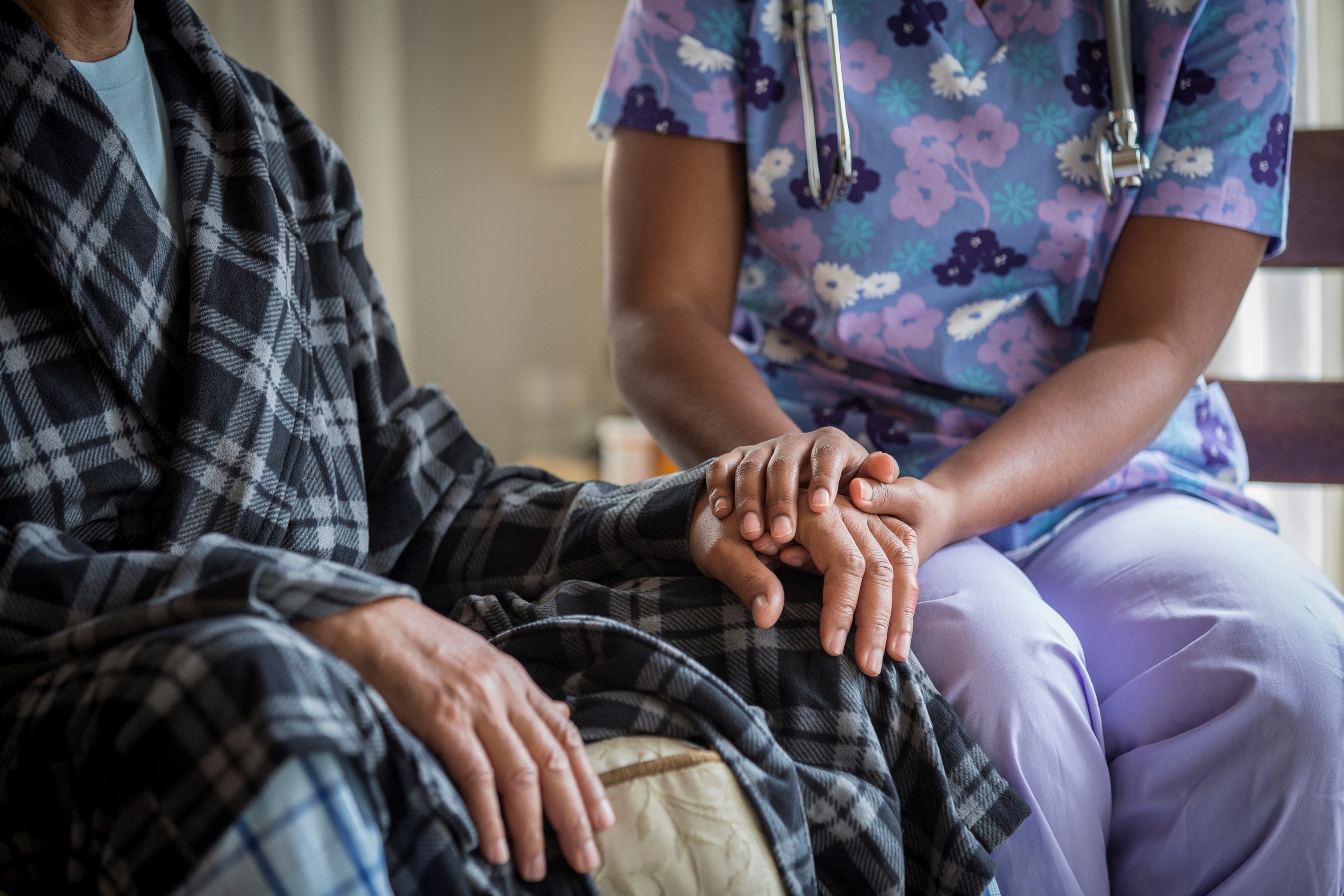 nurse and patient holding hands